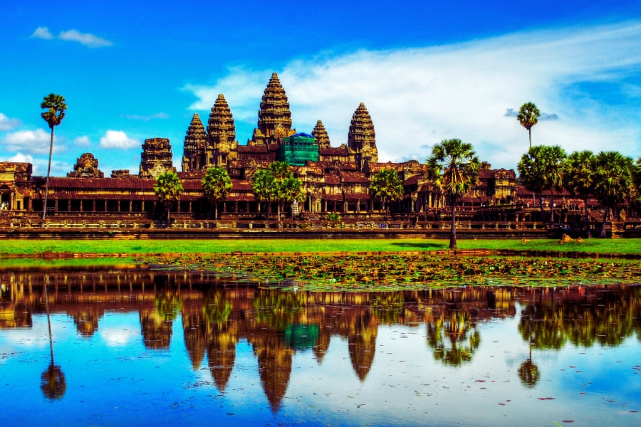 Angkor Wat temple reflected on lotus lake under blue sky in Cambodia – Auasia Travel